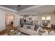 Open concept kitchen and living area with white cabinets, stainless steel appliances, and an island with seating at 851 Arbor Green Trl, St Cloud, FL 34771