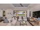 Living room with comfortable seating, a large TV, and sliding glass doors leading to the patio at 851 Arbor Green Trl, St Cloud, FL 34771