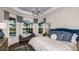 Spacious main bedroom with blue upholstered headboard, large windows, and a view of the pool at 851 Arbor Green Trl, St Cloud, FL 34771
