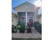 House exterior featuring a columned entryway, landscaping, and brick walkway at 912 Hire Cir, Ocoee, FL 34761