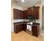 Kitchen with dark wood cabinets, granite countertops and stainless steel appliances at 912 Hire Cir, Ocoee, FL 34761