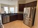 Kitchen with dark wood cabinets, granite countertops, and stainless steel appliances at 912 Hire Cir, Ocoee, FL 34761