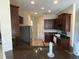 Modern kitchen with dark wood cabinets and granite countertops at 912 Hire Cir, Ocoee, FL 34761
