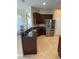 Kitchen with dark wood cabinets, granite countertops, and stainless steel appliances at 912 Hire Cir, Ocoee, FL 34761