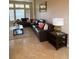 Living room featuring a large sectional sofa and tile floors at 912 Hire Cir, Ocoee, FL 34761