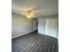 Spacious bedroom featuring wood-look floors and ceiling fan at 1023 S Hiawassee Rd # 4022, Orlando, FL 32835