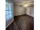Large bedroom with wood-look floors and a window at 1023 S Hiawassee Rd # 4022, Orlando, FL 32835