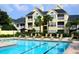 Community pool with apartment building in background at 1023 S Hiawassee Rd # 4022, Orlando, FL 32835