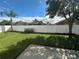 Spacious backyard with a grassy lawn, white vinyl fence, and a patio area at 10887 Flycast Cir, Orlando, FL 32825