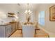 Elegant dining room featuring a large table, chandelier, and neutral decor at 113 Lena Ann Dr, Saint Cloud, FL 34771