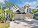 Two-story house with a double garage and a paved driveway at 113 Secluded Oaks Ct, Casselberry, FL 32707