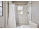 Clean bathroom with shower, toilet, and white tile at 1468 Deer Lake Cir, Apopka, FL 32712