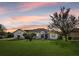 Charming home exterior at sunset with a well-manicured lawn at 17640 Las Brisas Ct, Winter Garden, FL 34787