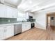 Bright kitchen with white cabinets, stainless steel appliances, and green tile backsplash at 1818 6Th Se St, Winter Haven, FL 33880