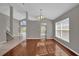 Dining area with hardwood floors, neutral walls, and view to kitchen at 2235 Mallory Cir, Haines City, FL 33844