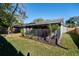 Screened patio and grassy backyard with palm trees at 328 Springview Dr, Sanford, FL 32773