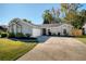 Inviting exterior of a single-story home with a spacious driveway and well-maintained landscaping at 328 Springview Dr, Sanford, FL 32773