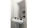 Small powder room with pedestal sink and large mirror at 3337 Private Oak Dr, Apopka, FL 32703