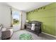 Charming Bedroom with green walls and crib at 3337 Private Oak Dr, Apopka, FL 32703