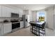 Modern kitchen featuring stainless steel appliances and granite countertops at 3337 Private Oak Dr, Apopka, FL 32703