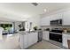 Open concept kitchen with island, stainless steel appliances, and granite countertops at 3337 Private Oak Dr, Apopka, FL 32703