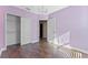 Purple bedroom with hardwood floors, double doors to closet, and chandelier at 4000 Messina Dr, Lake Mary, FL 32746