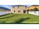 Large backyard with a grassy area, and a white vinyl fence at 4718 Rockvale Dr, Kissimmee, FL 34758