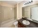 Clean bathroom with a single sink, shower/tub combo, and tile floors at 4718 Rockvale Dr, Kissimmee, FL 34758