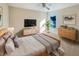 Light and airy bedroom with a dresser, nightstand, and a large TV at 4718 Rockvale Dr, Kissimmee, FL 34758