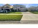 Two-story house with a paved driveway and a well-maintained lawn at 4718 Rockvale Dr, Kissimmee, FL 34758