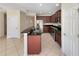 Kitchen with dark wood cabinets, granite counters, and stainless steel appliances at 4718 Rockvale Dr, Kissimmee, FL 34758