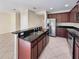 Kitchen with dark wood cabinets, granite counters, and stainless steel appliances at 4718 Rockvale Dr, Kissimmee, FL 34758