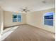 Spacious main bedroom with dual windows and ceiling fan at 4718 Rockvale Dr, Kissimmee, FL 34758