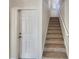 Modern staircase with carpeted steps and white railing at 4718 Rockvale Dr, Kissimmee, FL 34758