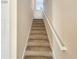 Carpeted staircase with a simple white handrail at 4718 Rockvale Dr, Kissimmee, FL 34758