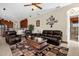 Comfortable living room featuring leather sofas and a coffee table at 6167 Hedgesparrows Ln, Sanford, FL 32771