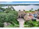 Waterfront home nestled amongst lush trees with a large lot and beautiful landscaping at 6245 Little Lake Sawyer Dr, Windermere, FL 34786