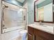 Bathroom with shower/tub combo, granite countertop vanity, and mosaic tile accents at 6245 Little Lake Sawyer Dr, Windermere, FL 34786