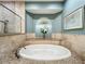 Relaxing bathroom with soaking tub, walk-in shower, and stylish tile at 6245 Little Lake Sawyer Dr, Windermere, FL 34786