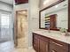 Spa-like bathroom with walk-in shower, granite vanity, and access to a private balcony at 6245 Little Lake Sawyer Dr, Windermere, FL 34786