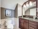 Elegant powder room with dark wood vanity and granite countertop at 6245 Little Lake Sawyer Dr, Windermere, FL 34786