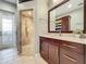 Spa-like bathroom with walk-in shower, granite vanity, and access to a private balcony at 6245 Little Lake Sawyer Dr, Windermere, FL 34786