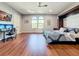 Multifunctional bedroom with a murphy bed, workspace, and hardwood floors at 6245 Little Lake Sawyer Dr, Windermere, FL 34786