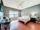 Peaceful bedroom with lake view and hardwood floors at 6245 Little Lake Sawyer Dr, Windermere, FL 34786