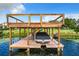 Covered boat lift on a spacious dock with boardwalk access at 6245 Little Lake Sawyer Dr, Windermere, FL 34786