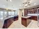 Open concept kitchen with large island, granite countertops, and stainless steel appliances at 6245 Little Lake Sawyer Dr, Windermere, FL 34786
