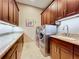Laundry room with granite countertops, cabinets, and a sink at 6245 Little Lake Sawyer Dr, Windermere, FL 34786