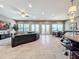 Open living room with leather sectional and access to backyard at 6245 Little Lake Sawyer Dr, Windermere, FL 34786