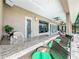 Outdoor kitchen with granite countertop and seating area at 6245 Little Lake Sawyer Dr, Windermere, FL 34786