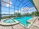 Enclosed pool and spa with a stunning lake view at 6245 Little Lake Sawyer Dr, Windermere, FL 34786